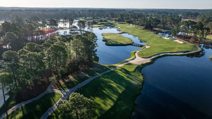 Aerial view of the island green par 3 at King's North with a bridge crossing the water