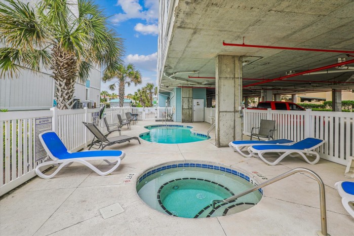 The outdoor pool and hot tub on the shaded deck at Ambassador Villas