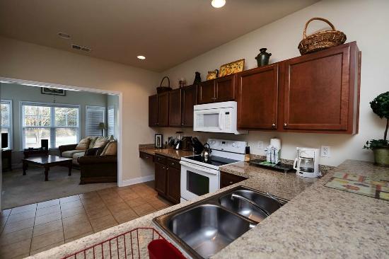 Full kitchen in a Barefoot condo with the living room beyond