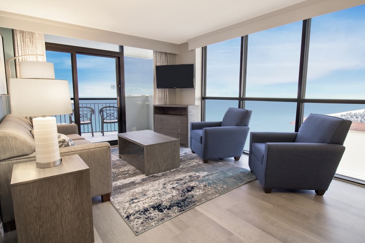 Living area of an oceanfront condo at Breakers Resort, with windows onto the water