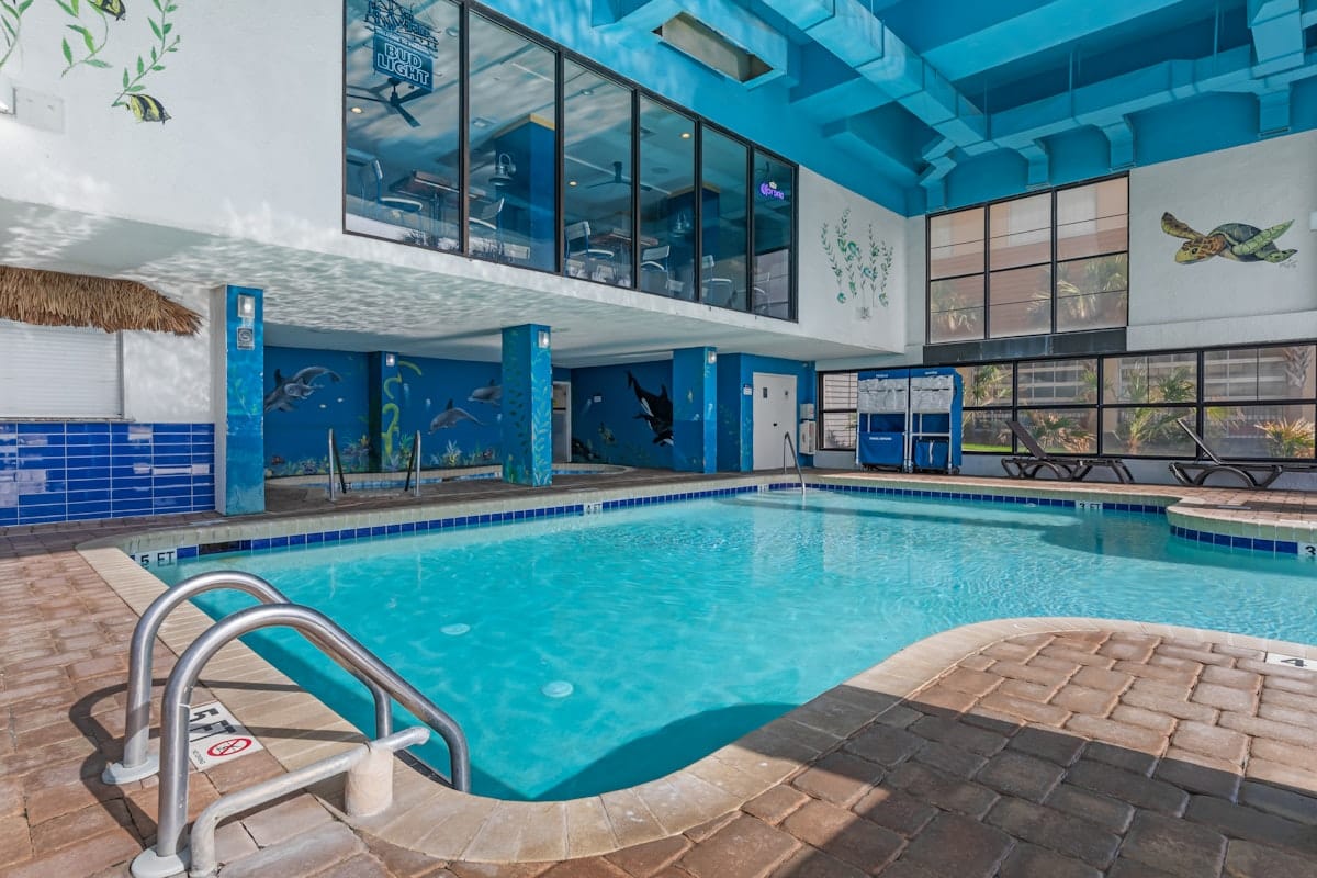 The indoor pool under the painted sea murals at Breakers Resort