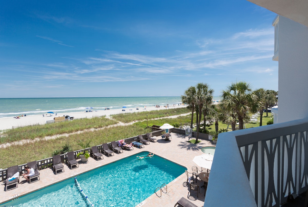 The ocean, the beach and the pool deck seen from a balcony at Caribbean Resort and Villas
