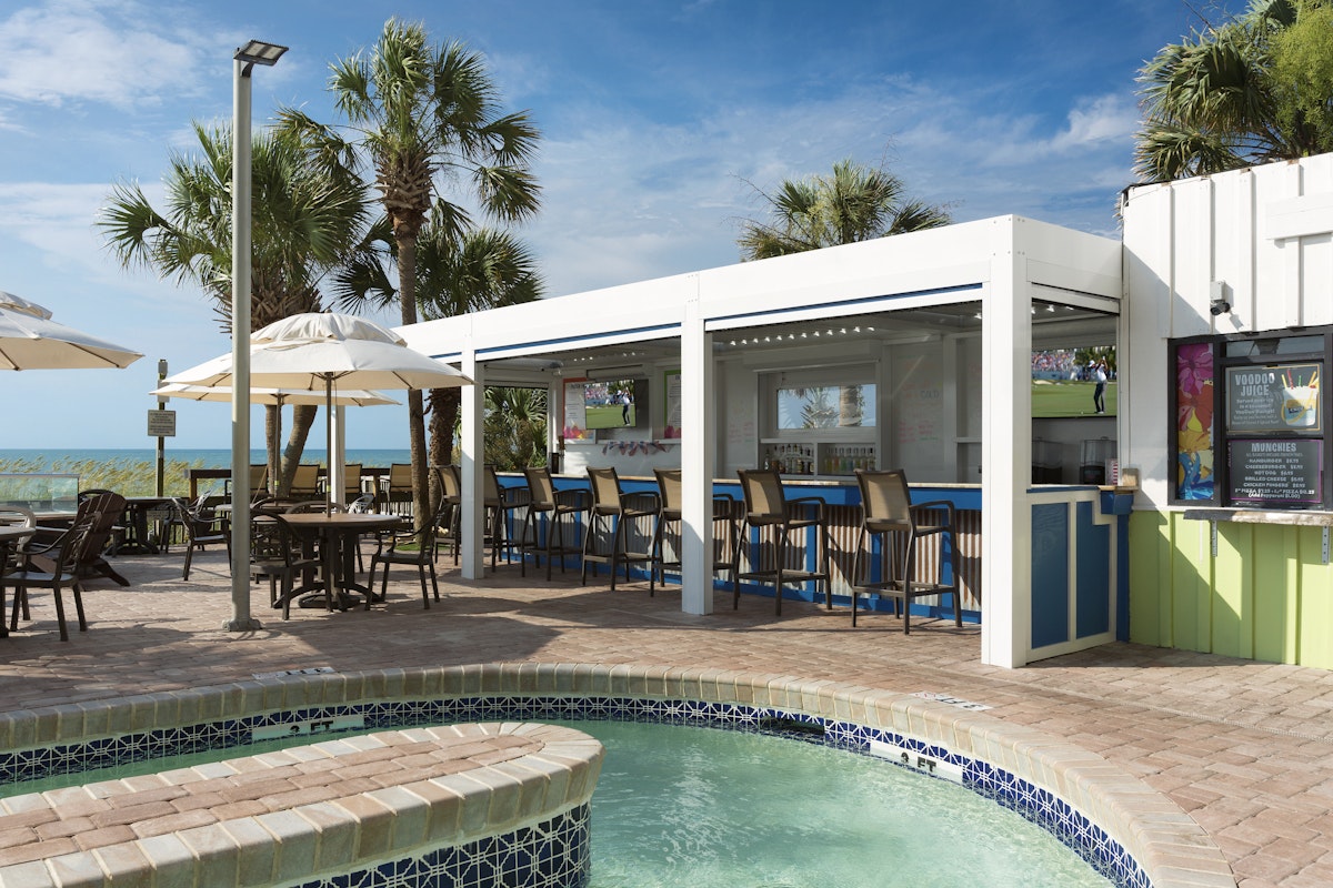 The oceanfront tiki bar and hot tub on the pool deck at Caribbean Resort and Villas