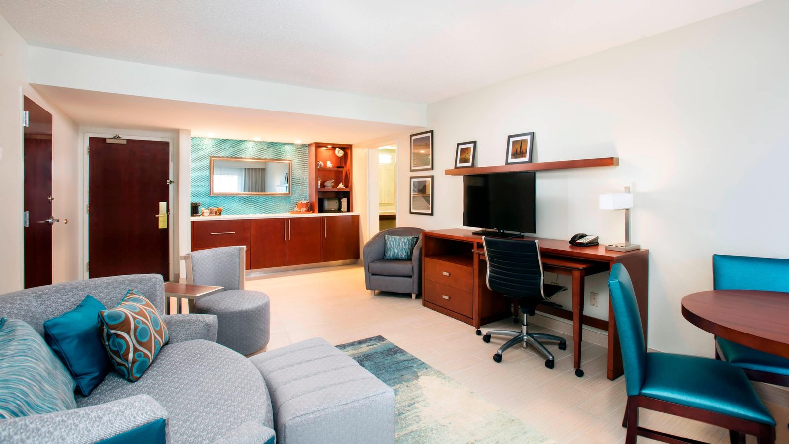 Suite at the Courtyard by Marriott with a seating area, work desk and kitchenette
