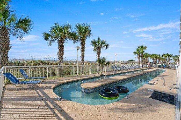The oceanfront outdoor pool and palms at Crescent Shores