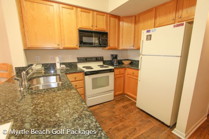 Villa kitchen at Legends with granite counters, a full range and a breakfast bar