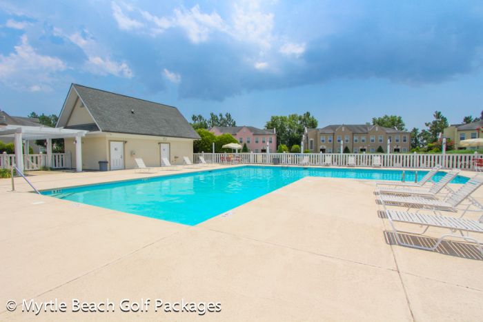 The community outdoor pool and sun loungers with the Legends villas behind