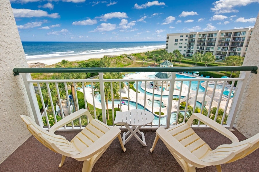 The ocean, the beach and the pool deck seen from a balcony at the resort's Bridgewater building