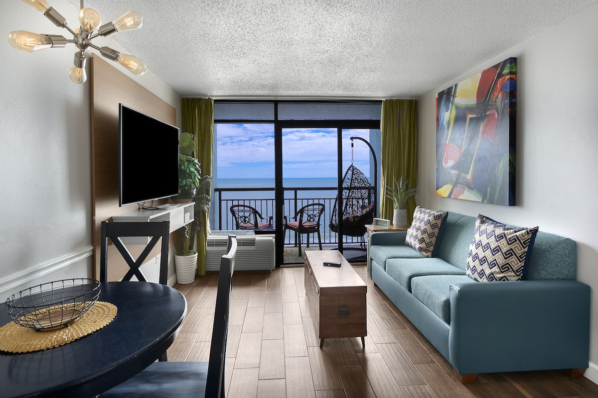 Living area of an oceanfront suite at Monterey Bay Suites, looking out to the water
