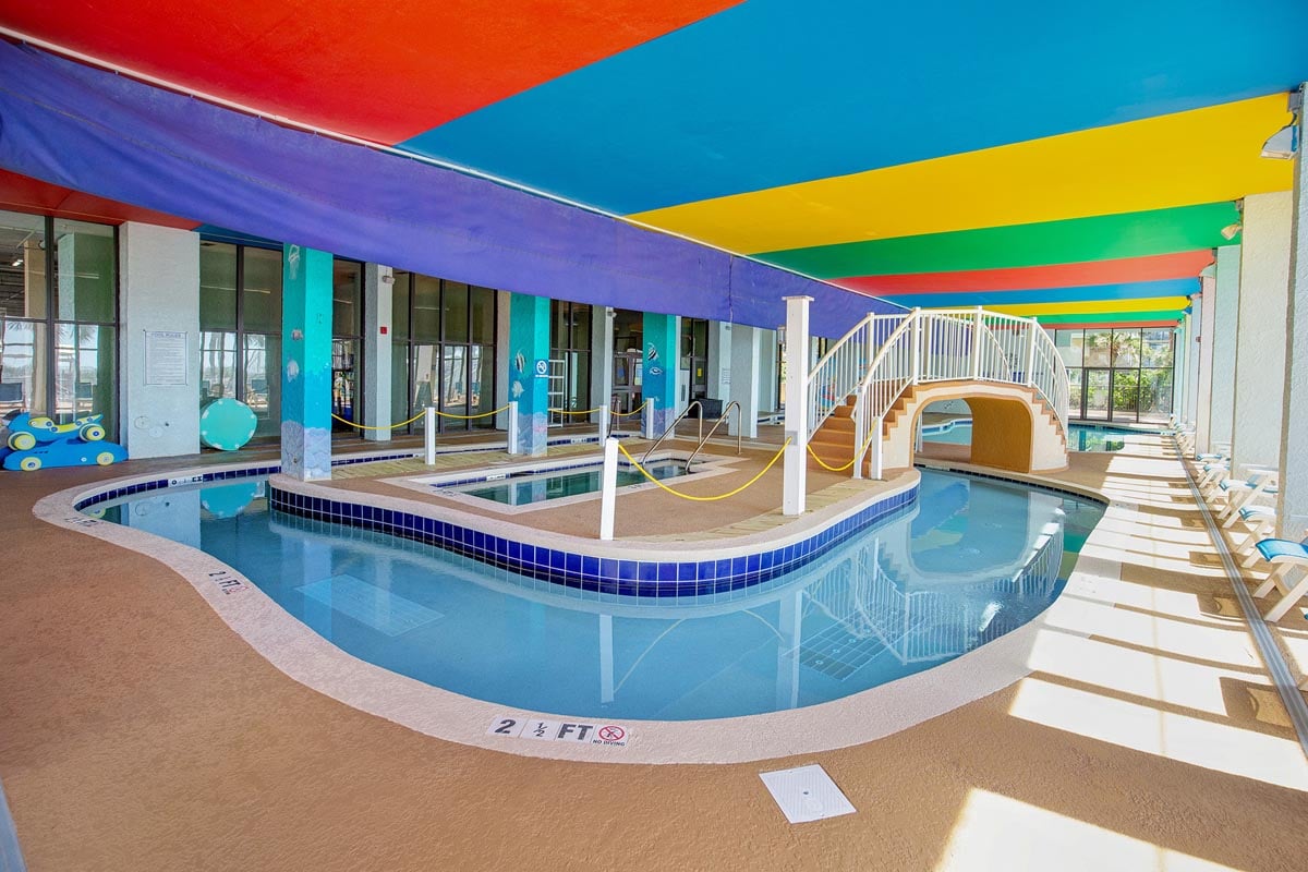 The indoor lazy river under its painted canopy at Monterey Bay Suites
