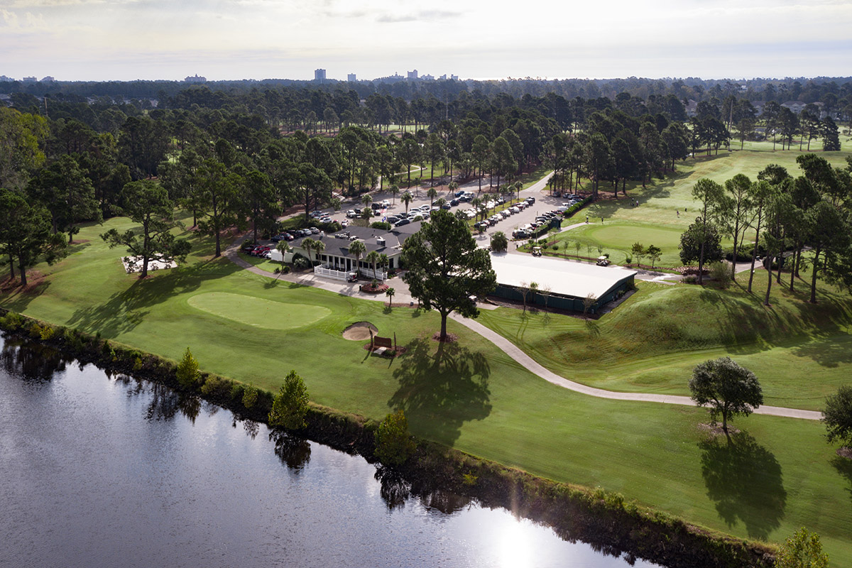 The Myrtlewood clubhouse from the air, with the course and the lake around it