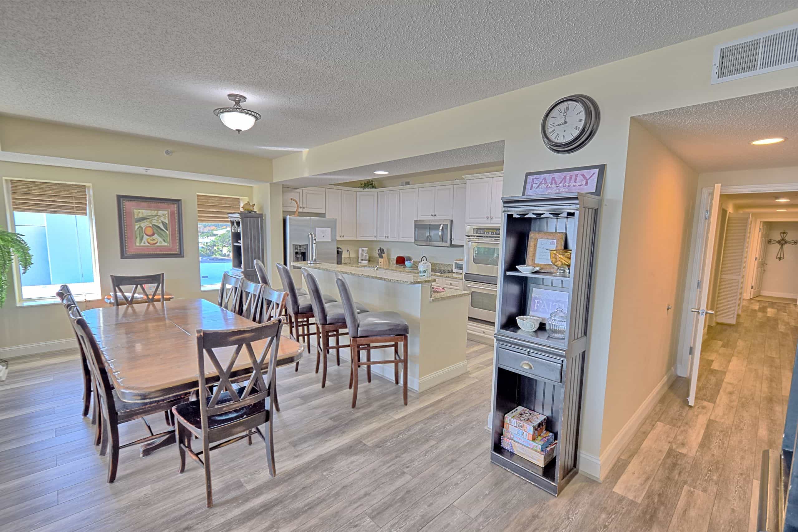 Condo kitchen and dining area at Ocean Blue Resort, with a granite breakfast bar