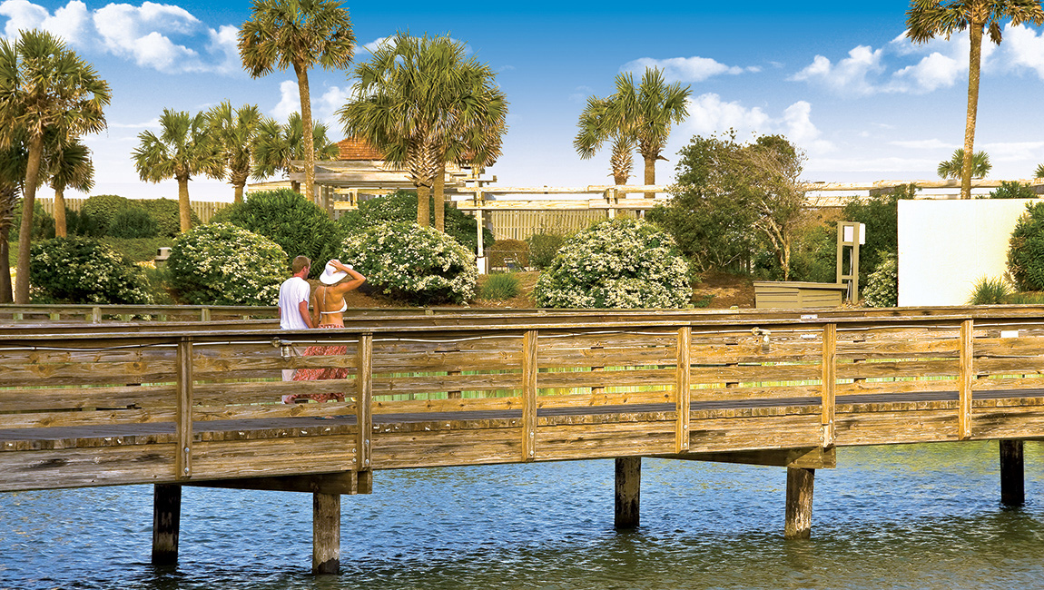 The wooden footbridge over the creek to the beach club at Ocean Creek Resort