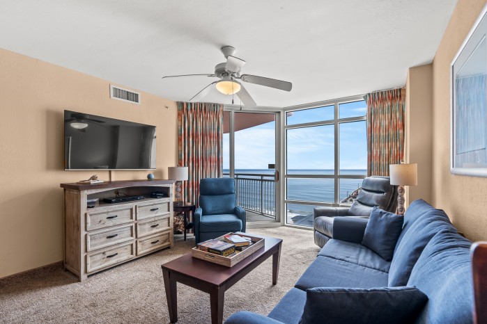 Living area of an oceanfront condo at the Prince Resort, looking through the balcony doors to the water