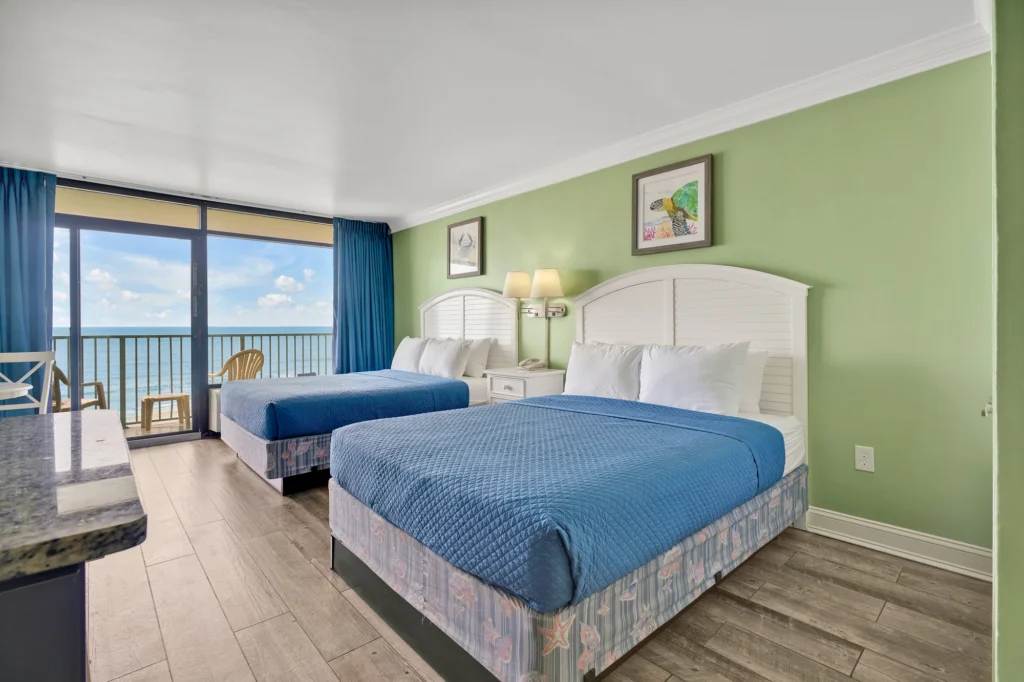 Oceanfront room at Sand Dunes Resort, with the balcony doors open to the water