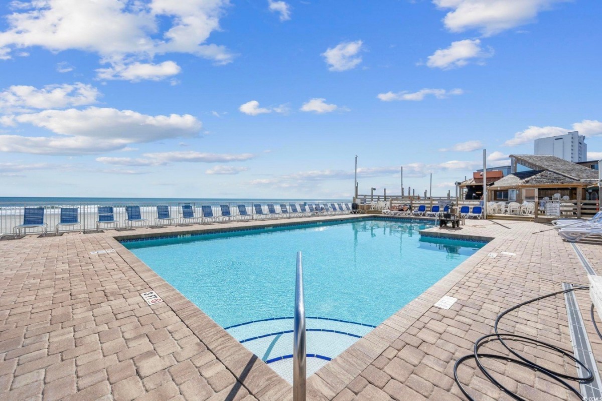 The oceanfront pool and sun loungers looking out to the beach at Sands Ocean Club