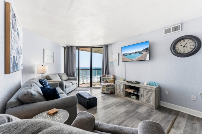 Living area of a condo at Sands Ocean Club, with the ocean through the balcony doors
