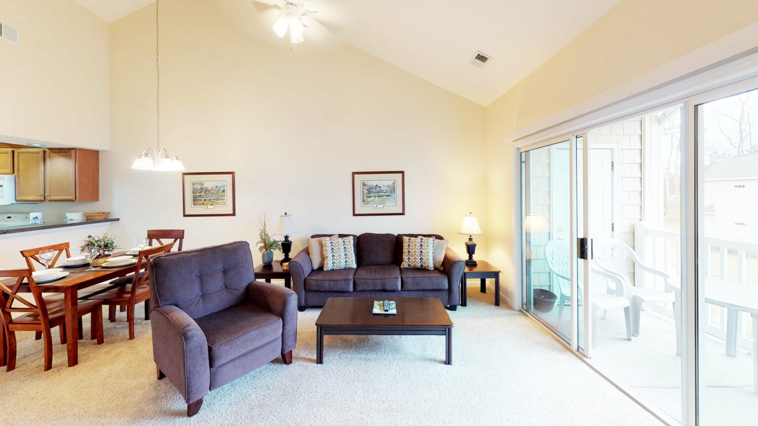 Open living and dining area under a vaulted ceiling in a villa at Village at the Glens