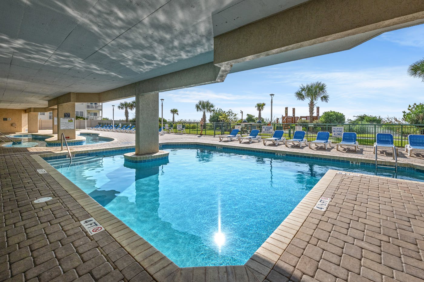 The outdoor pool and hot tub on the shaded deck at Windy Hill Dunes