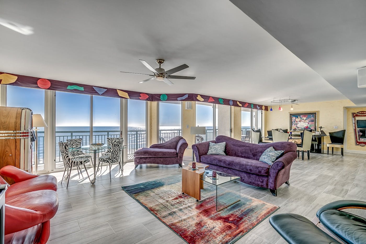 Living area of an oceanfront condo at Windy Hill Dunes, with windows the length of the room